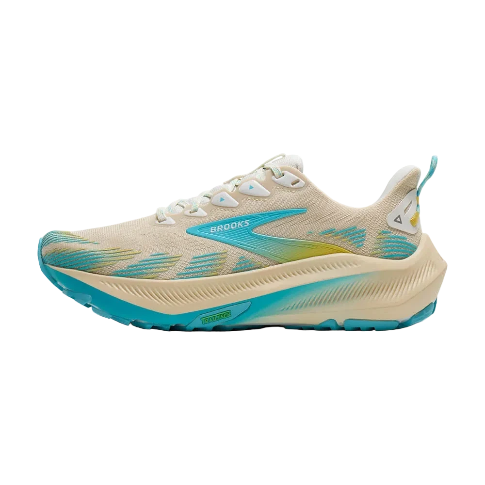 Beige and blue running shoe with yellow sole on a white background