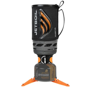 Jetboil Flash 3-in-1 camping stove system with a black insulated pot sleeve, orange accents, and a gray fuel canister on a black background.