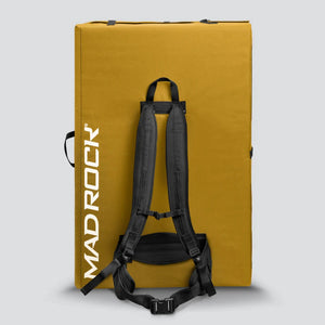 A Saffron yellow MAD ROCK climbing pad with black shoulder straps and buckles, shown from the back against a white background.