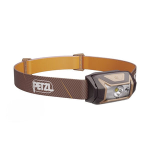 Headlamp with brown strap and visible Petzl logo on a white background