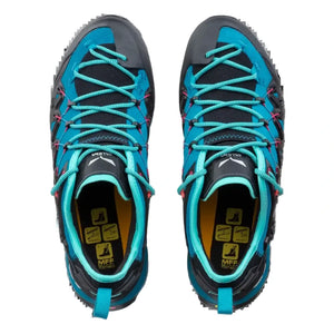 Top view of a Salewa approach shoe in turquoise, black, and pink, featuring a black rubber toe cap and turquoise laces on a white background.