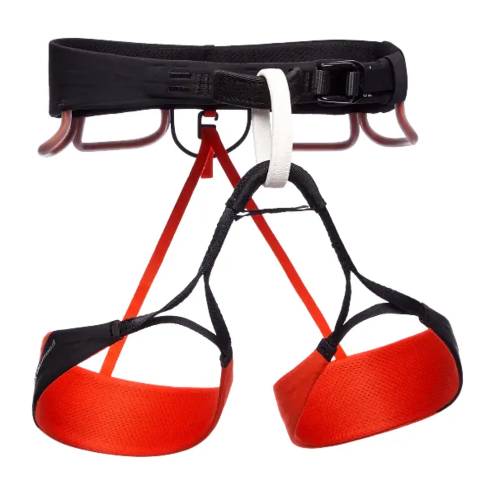 Red and black climbing harness with a white carabiner on a white background